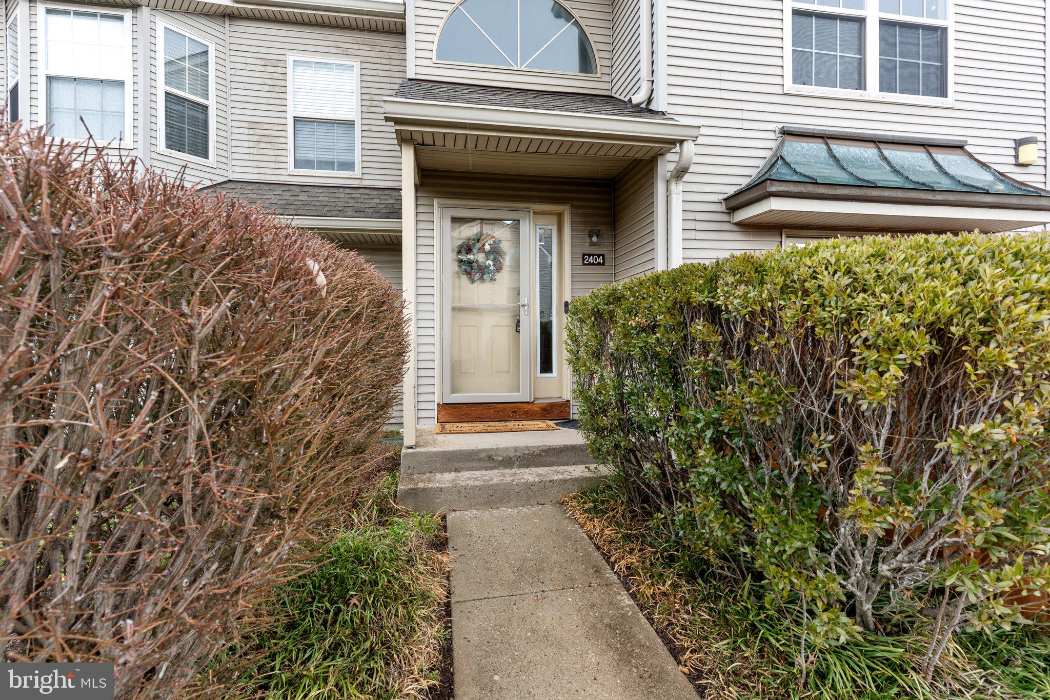 2404 Brookhaven Drive, Unit 330 Yardley, PA 19067 - Photo 25 of 27 a view of a house with a small yard and plants