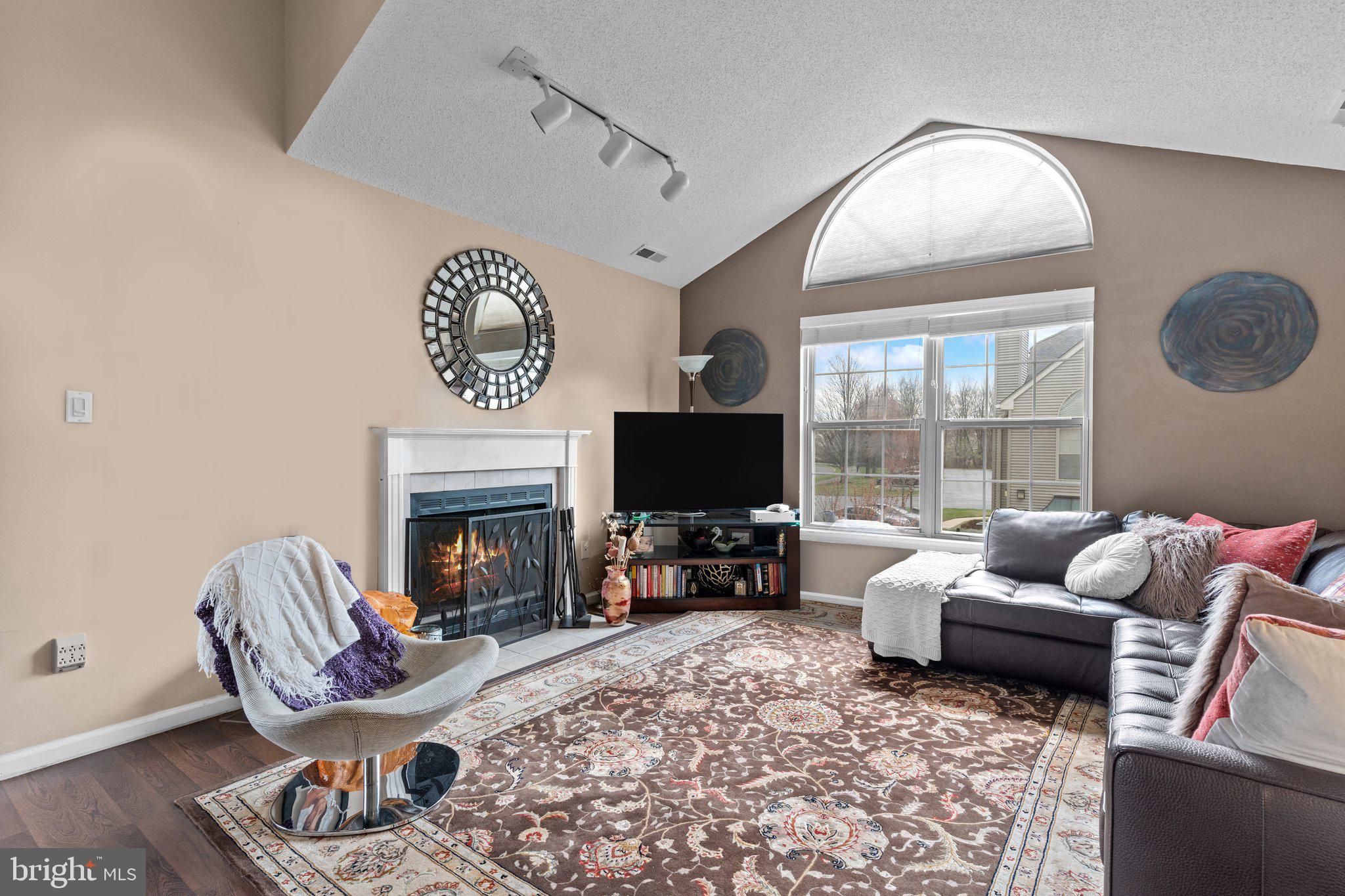 2404 Brookhaven Drive, Unit 330 Yardley, PA 19067 - Photo 3 of 27 a living room with furniture a fireplace and a flat screen tv