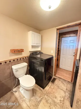 a bathroom with a toilet a sink a vanity and mirror