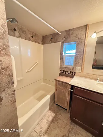 a bathroom with a bathtub and a sink