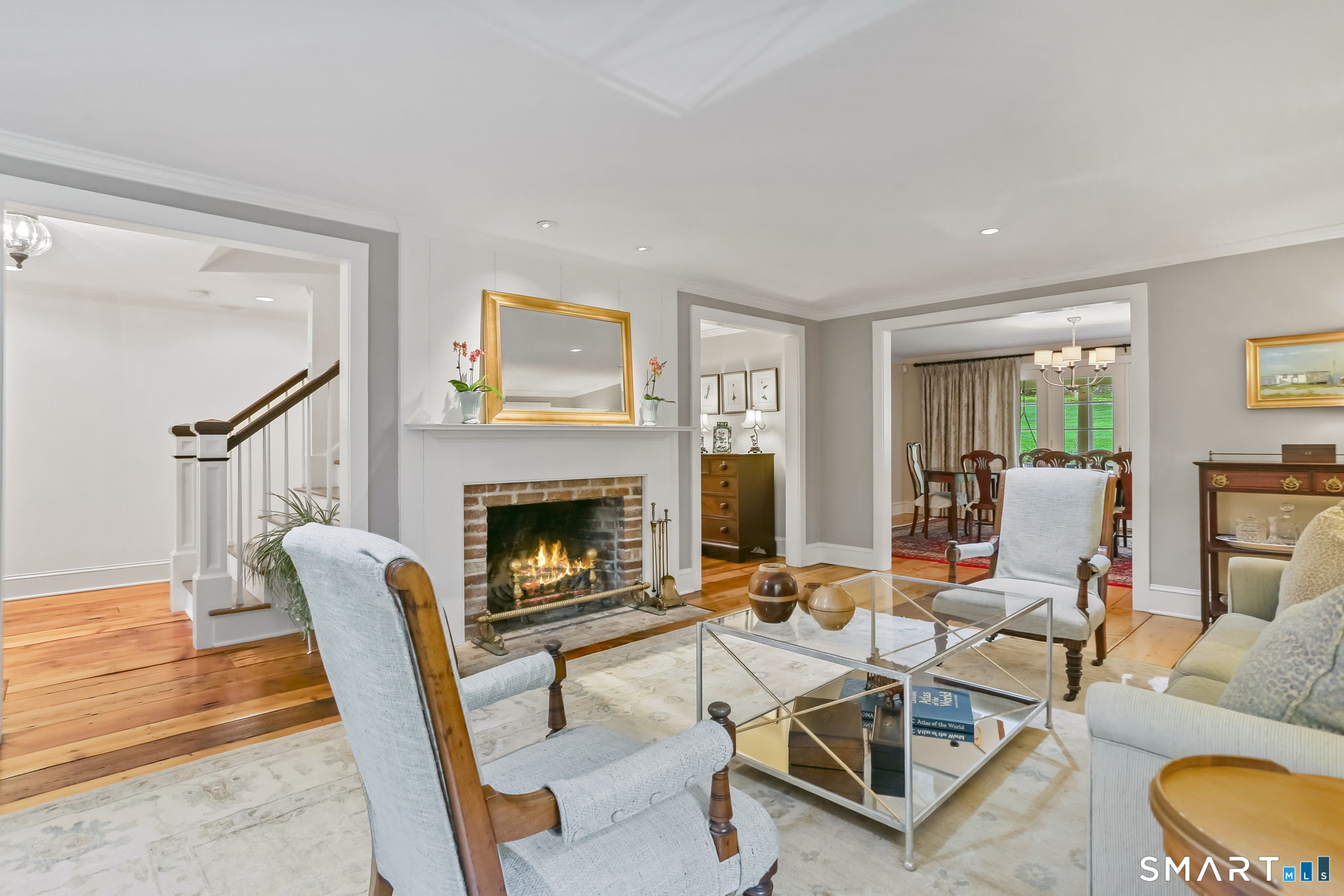 23 Old Stage Coach Road Weston, CT 06883 - Photo 7 of 37 a living room with furniture a fireplace and a table