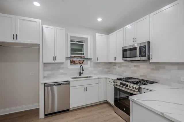 a kitchen with a sink stove and cabinets