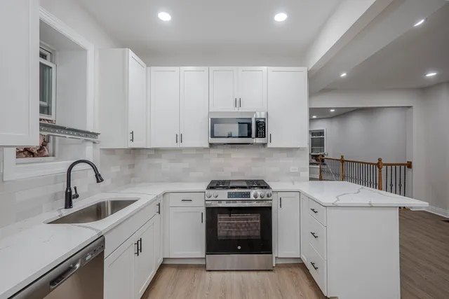 a bathroom with a toilet sink vanity and mirror