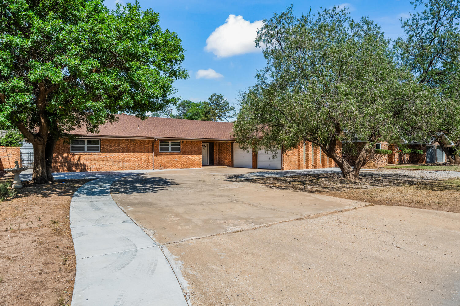 2028 Rice Drive Levelland, TX 79336 - Photo 2 of 25 a front view of a house with a yard and garage