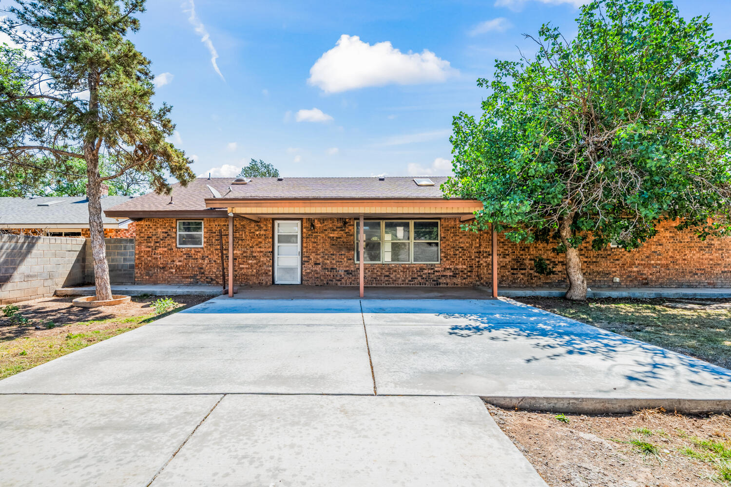 2028 Rice Drive Levelland, TX 79336 - Photo 21 of 25 a view of a white house with a large tree