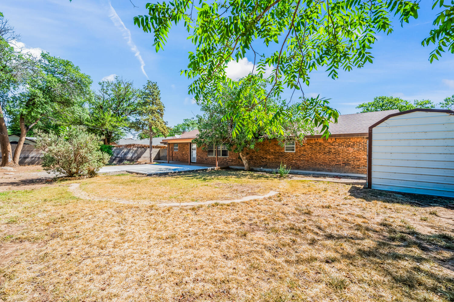 2028 Rice Drive Levelland, TX 79336 - Photo 25 of 25 a view of a backyard with swimming pool