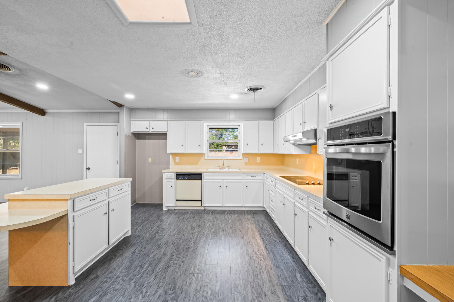 2028 Rice Drive Levelland, TX 79336 - Photo 6 of 25 a large kitchen with a large counter top a sink stainless steel appliances and cabinets