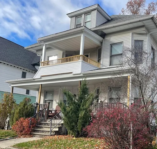 front view of house with potted plants