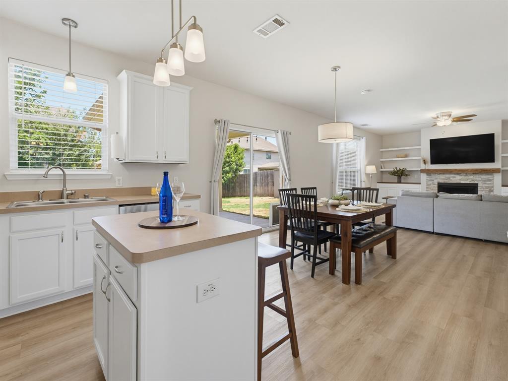 13268 Fencerow Road Fort Worth, TX 76244 - Photo 5 of 25 Open-concept living area featuring a kitchen island, dining space, and living room