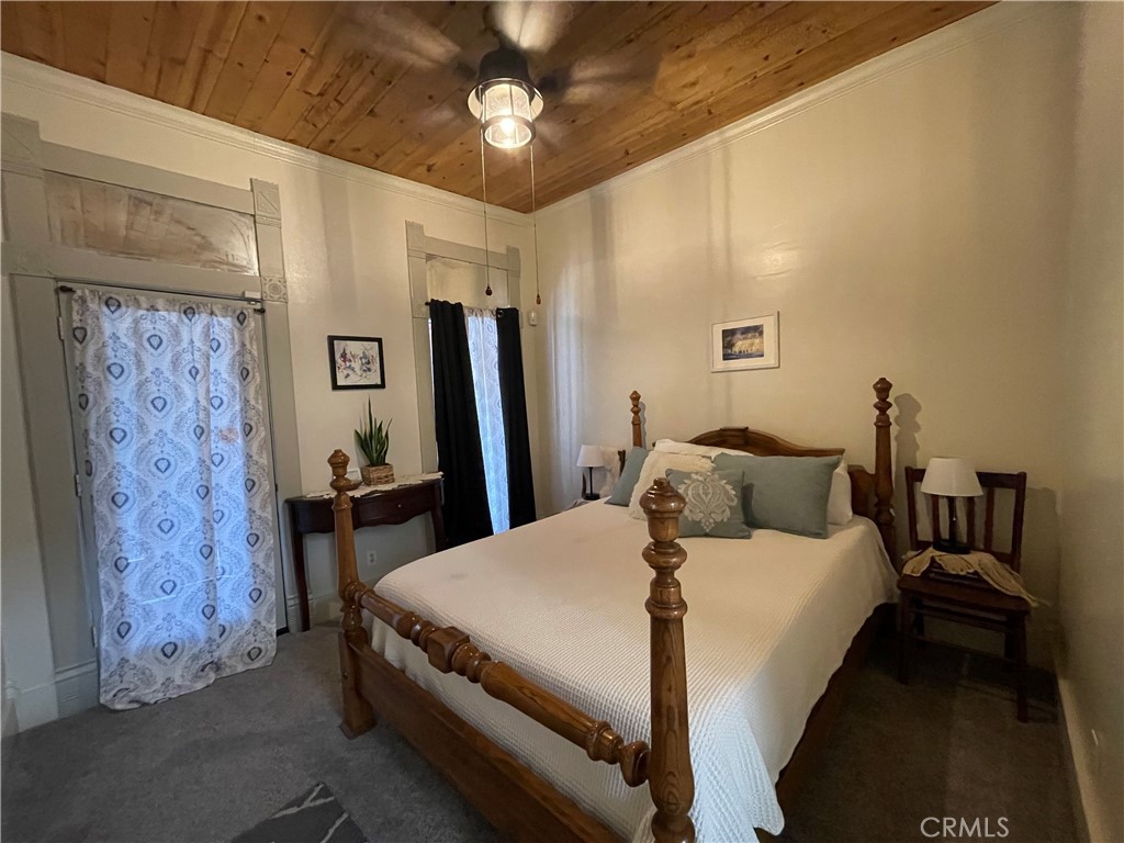 641 Main Street Red Bluff, CA 96080 - Photo 14 of 24 a bedroom with a bed and a chandelier