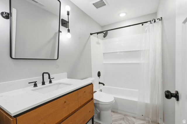 338 Windy Rdg Drive Smithfield, UT 84335 - Photo 48 of 63 Bathroom featuring a wood-finish vanity with a white countertop and integrated sink, matte black faucet, and a rectangular mirror with a black frame