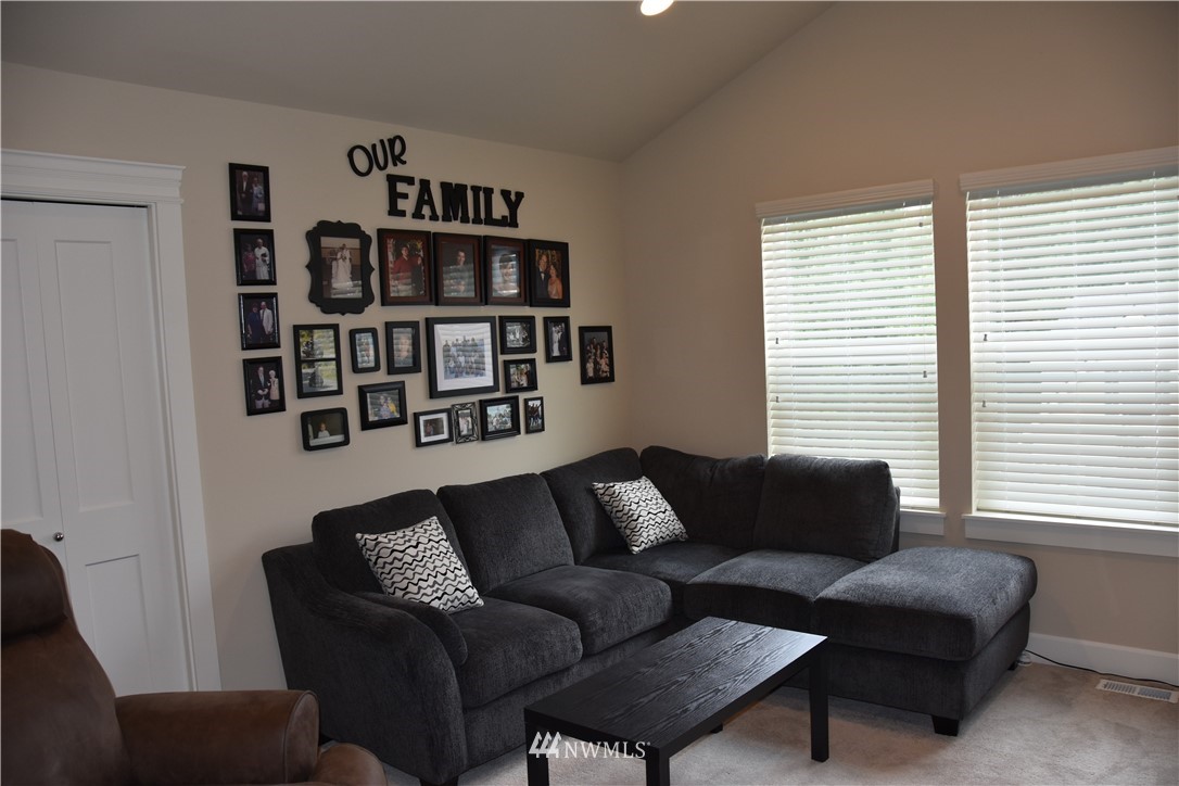 906 231st Street Southeast Bothell, WA 98021 - Photo 13 of 15 a living room with furniture and a window