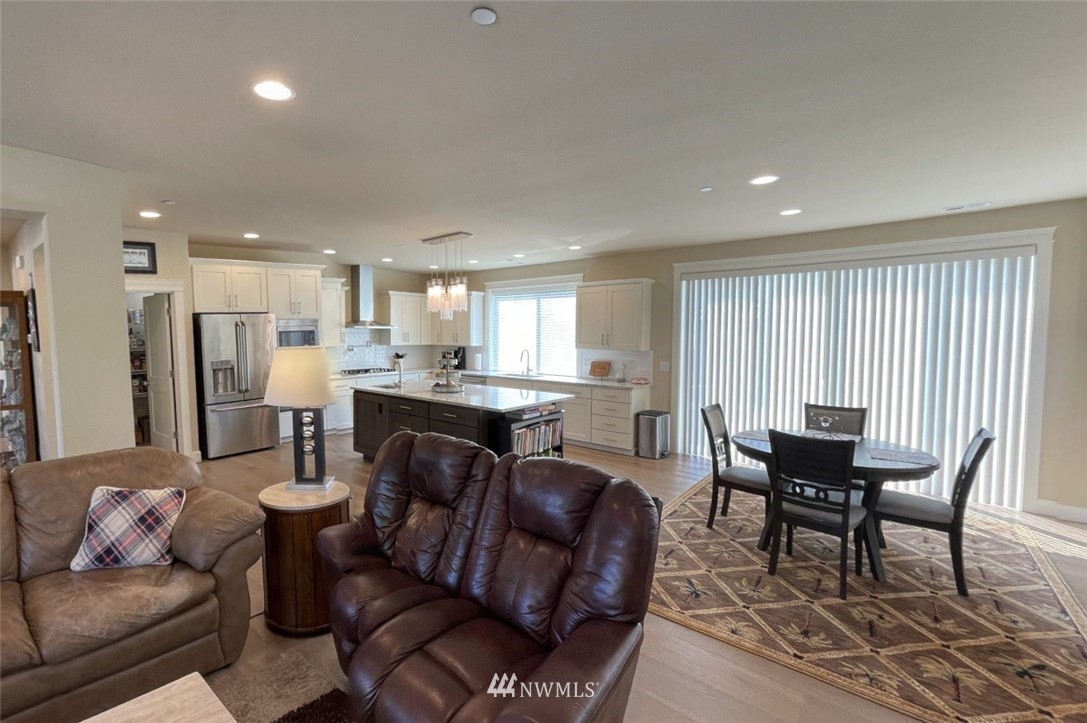 906 231st Street Southeast Bothell, WA 98021 - Photo 4 of 15 a living room with furniture and a dining table with kitchen view