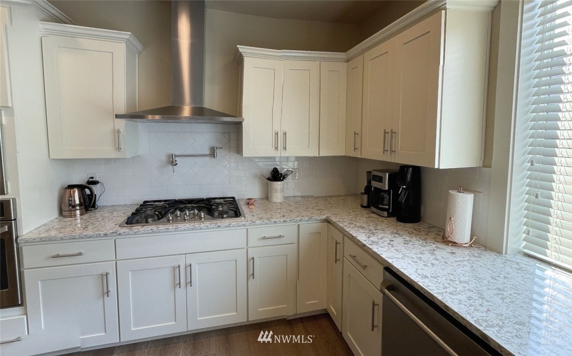 906 231st Street Southeast Bothell, WA 98021 - Photo 6 of 15 a kitchen with granite countertop white cabinets and white appliances