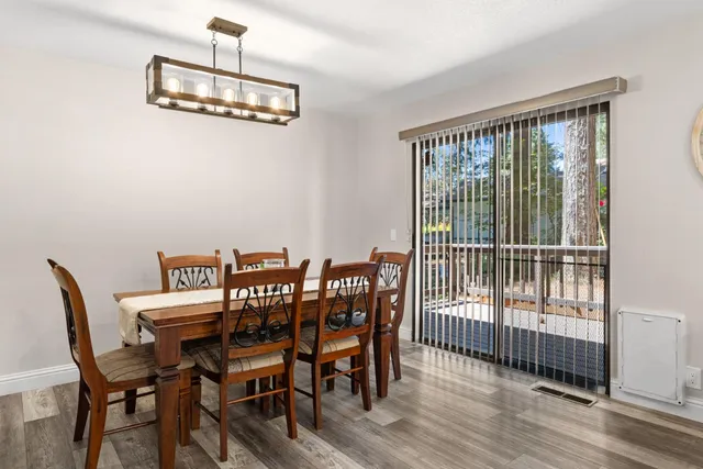 a view of a dining room with furniture wooden floor and chandelier