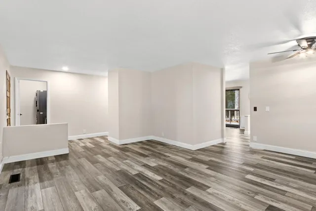 a view of an empty room and wooden floor