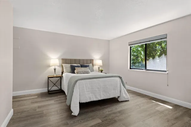 a bedroom with a bed and a window