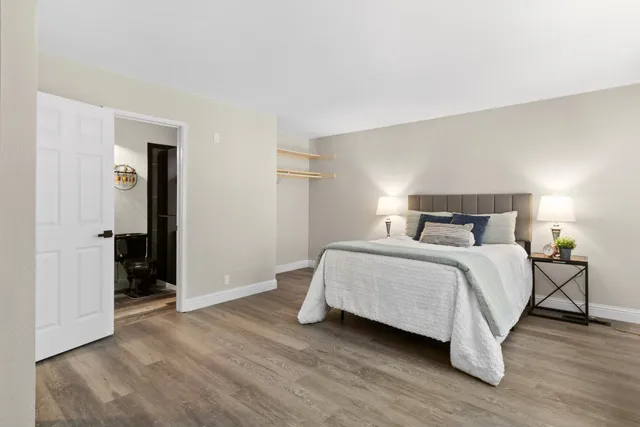 a bedroom with a bed and wooden floor