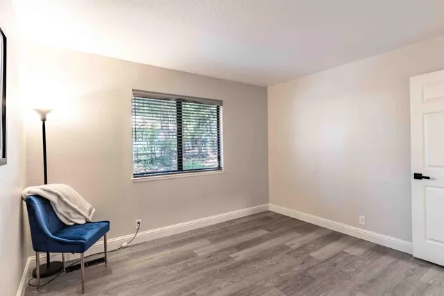 a view of a room with a chair and a window