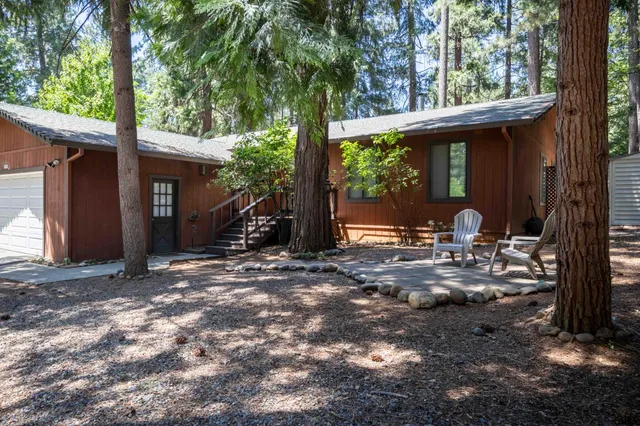 a view of a house with backyard porch and sitting area