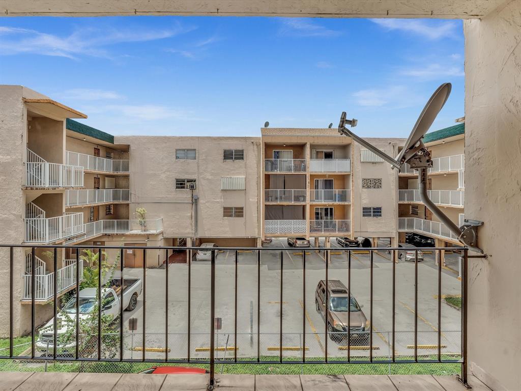 1075 West 68th Street, Unit 203 Hialeah, FL 33014 - Photo 20 of 41 a front view of a building with glass windows