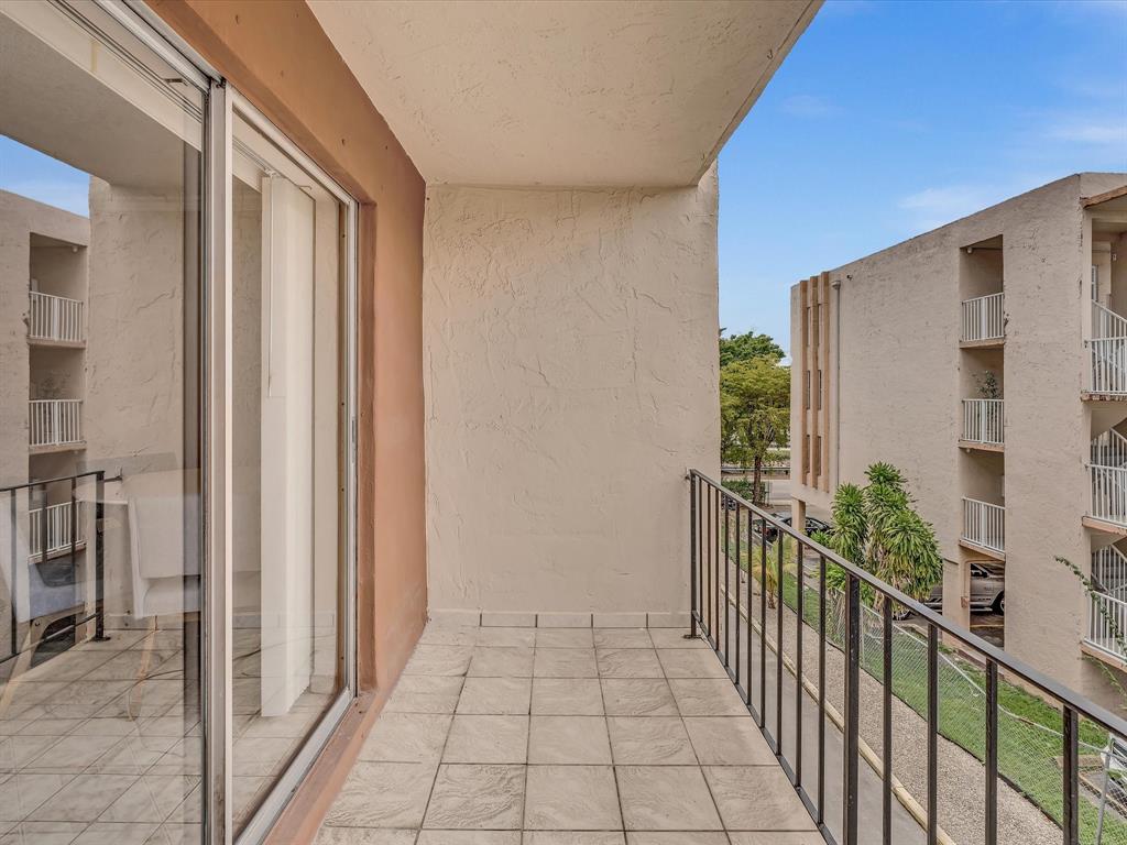 1075 West 68th Street, Unit 203 Hialeah, FL 33014 - Photo 22 of 41 a view of a door and wooden floor