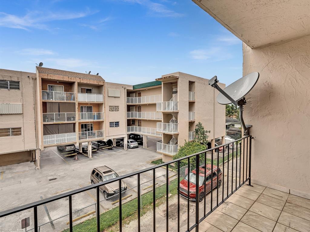 1075 West 68th Street, Unit 203 Hialeah, FL 33014 - Photo 23 of 41 a view of a building from a balcony