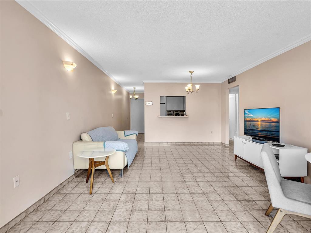 1075 West 68th Street, Unit 203 Hialeah, FL 33014 - Photo 25 of 41 a living room with furniture and a flat screen tv