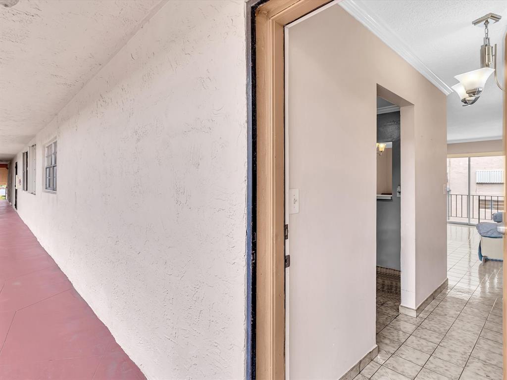 1075 West 68th Street, Unit 203 Hialeah, FL 33014 - Photo 3 of 41 a view of a hallway with two rooms