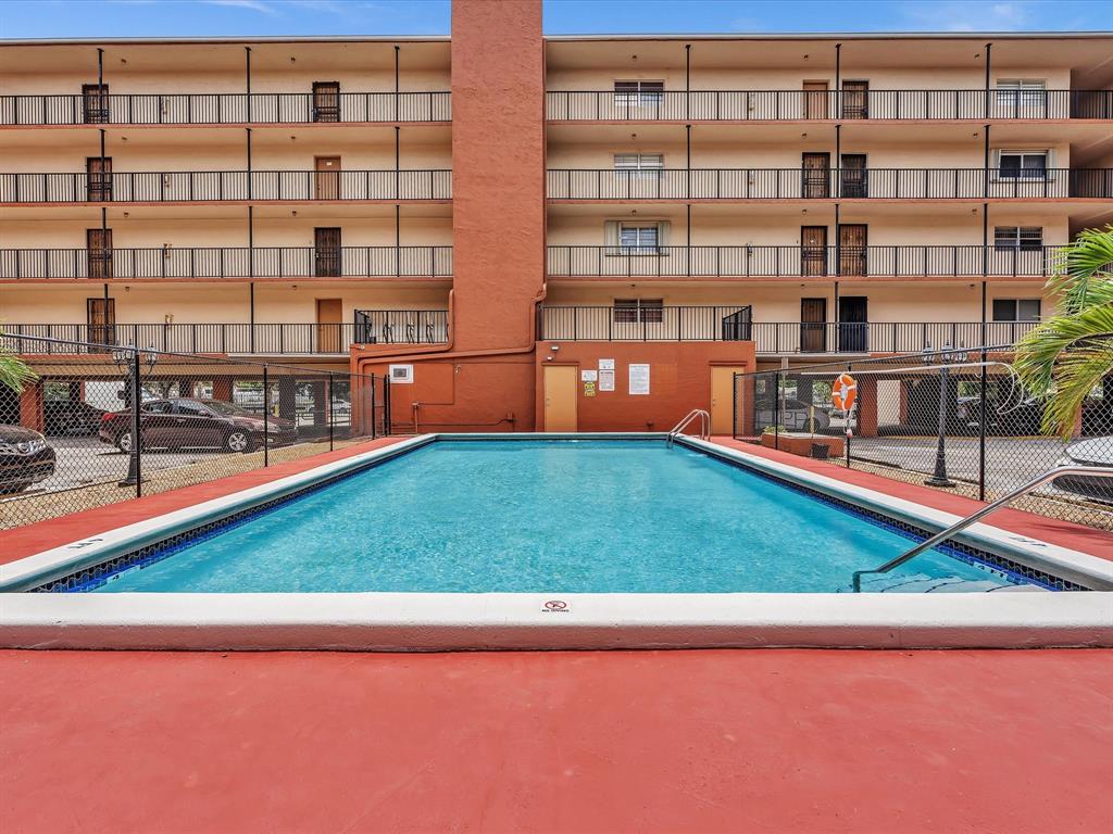 1075 West 68th Street, Unit 203 Hialeah, FL 33014 - Photo 34 of 41 a view of an apartment with a swimming pool and sitting area