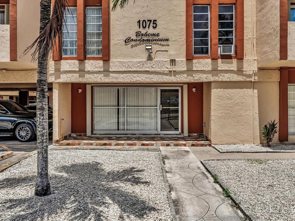 1075 West 68th Street, Unit 203 Hialeah, FL 33014 - Photo 35 of 41 a front view of a building with windows