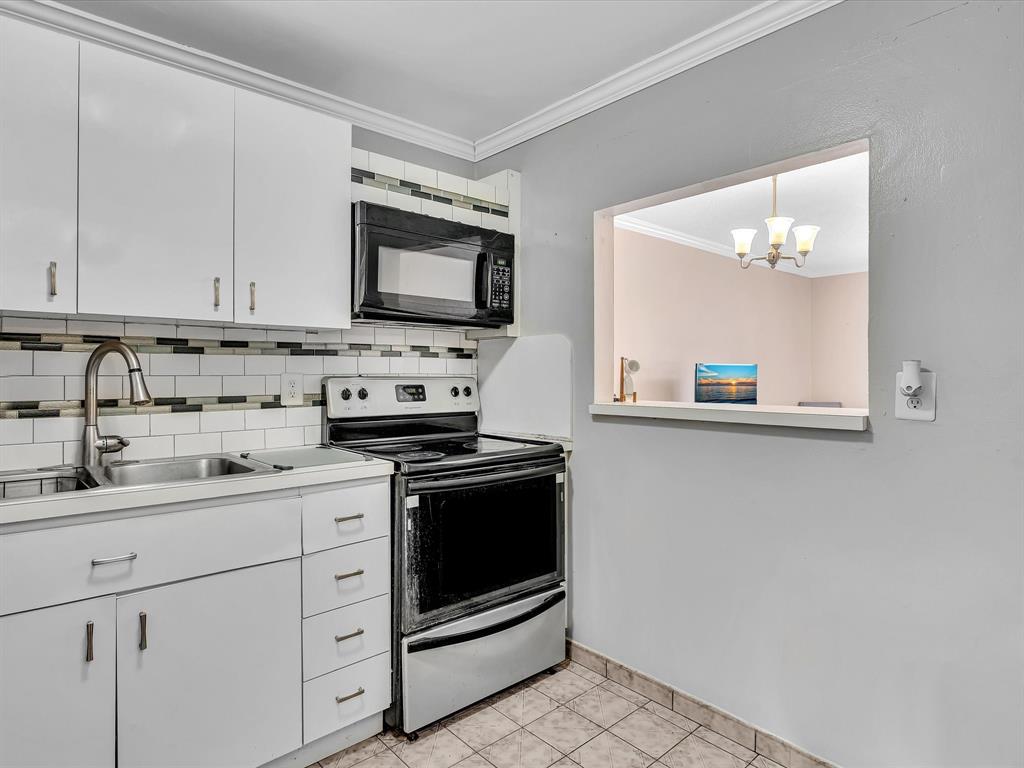 1075 West 68th Street, Unit 203 Hialeah, FL 33014 - Photo 5 of 41 a kitchen with stainless steel appliances granite countertop white cabinets stove a sink and dishwasher