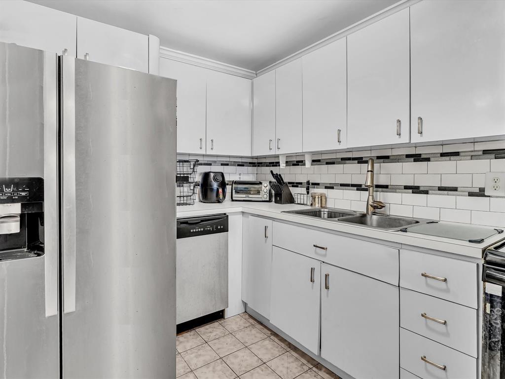 1075 West 68th Street, Unit 203 Hialeah, FL 33014 - Photo 7 of 41 a kitchen with appliances a sink and cabinets