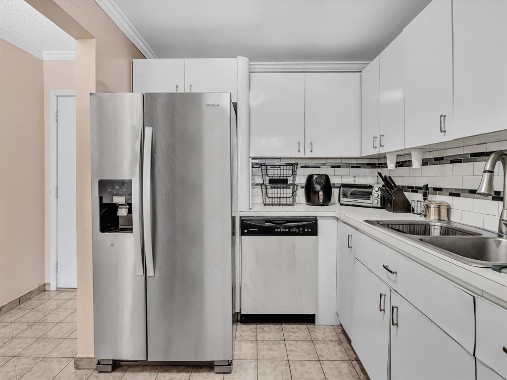 1075 West 68th Street, Unit 203 Hialeah, FL 33014 - Photo 8 of 41 a kitchen with stainless steel appliances a refrigerator sink and cabinets