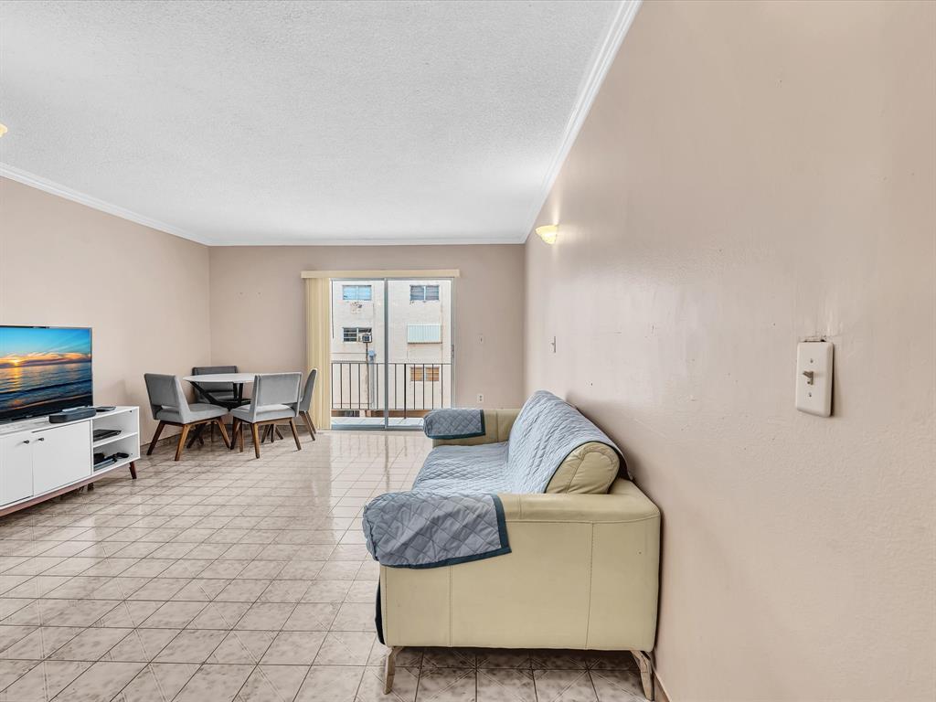 1075 West 68th Street, Unit 203 Hialeah, FL 33014 - Photo 10 of 41 a living room with furniture and a flat screen tv
