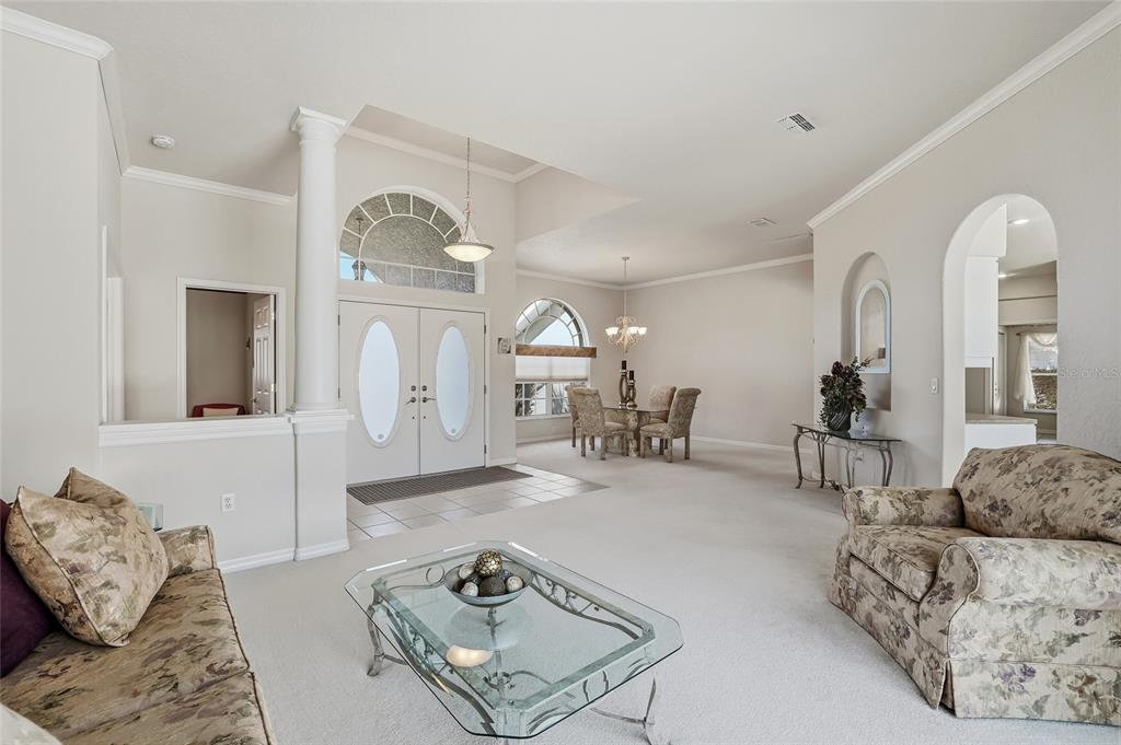 3521 Conifer Loop Spring Hill, FL 34609 - Photo 11 of 71 a living room with furniture a large window and potted plants
