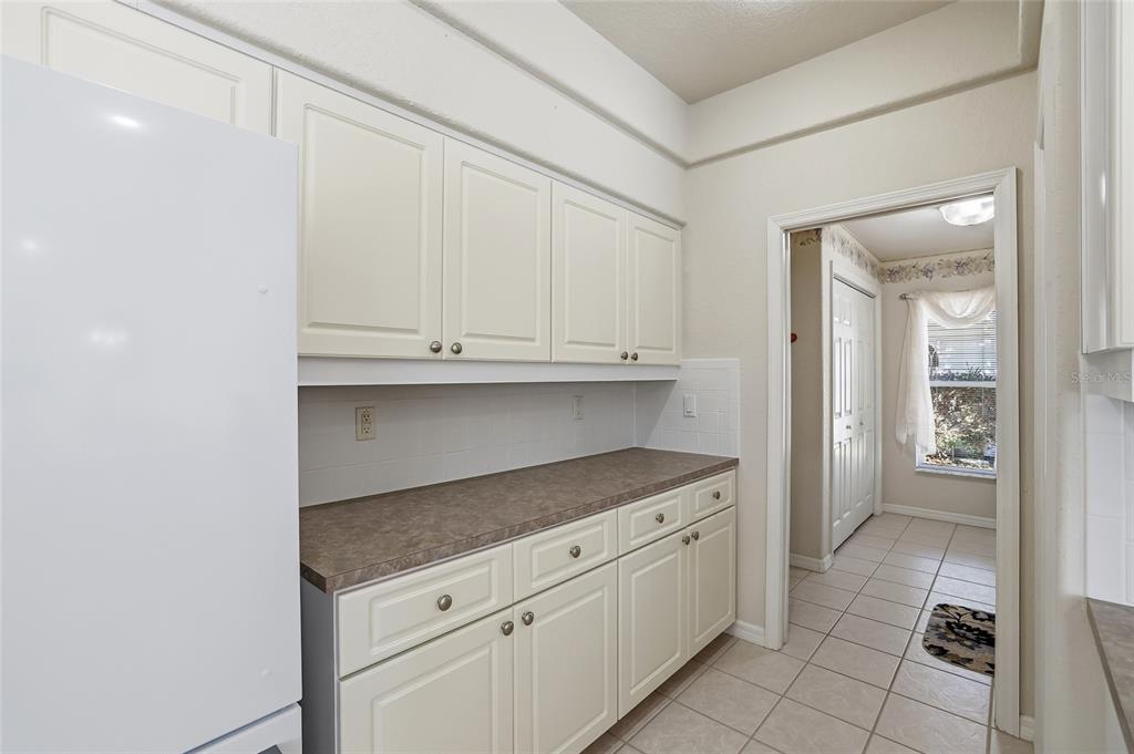 3521 Conifer Loop Spring Hill, FL 34609 - Photo 23 of 71 a kitchen with granite countertop white cabinets and stainless steel appliances