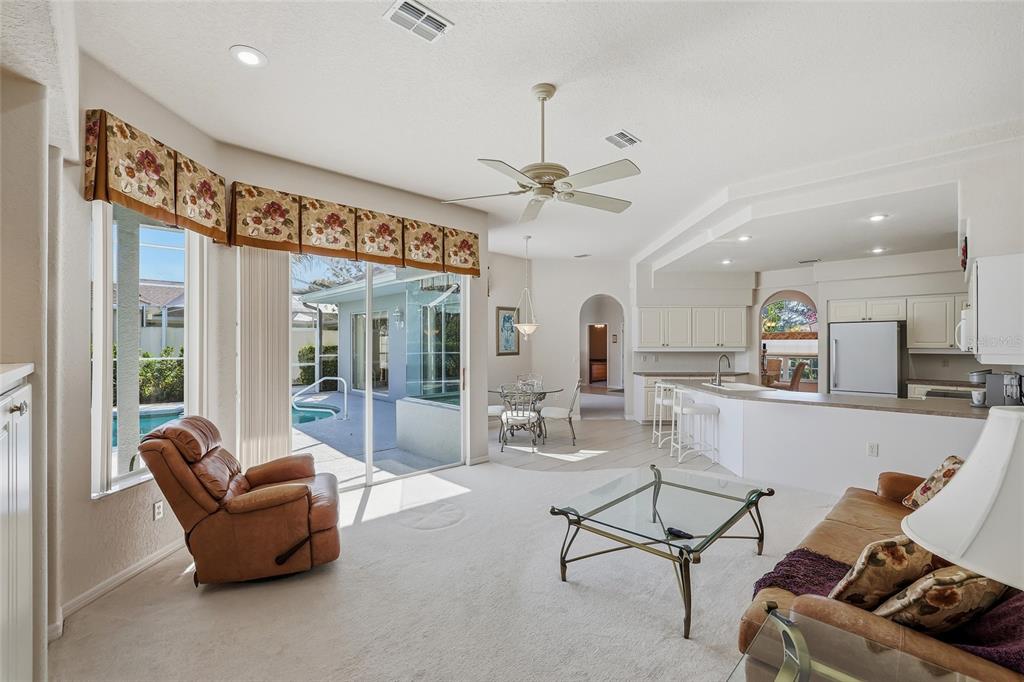 3521 Conifer Loop Spring Hill, FL 34609 - Photo 28 of 71 a living room with furniture a flat screen tv and a large window