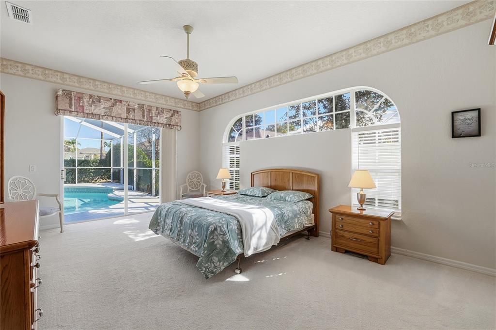 3521 Conifer Loop Spring Hill, FL 34609 - Photo 32 of 71 a spacious bedroom with a bed and a large window