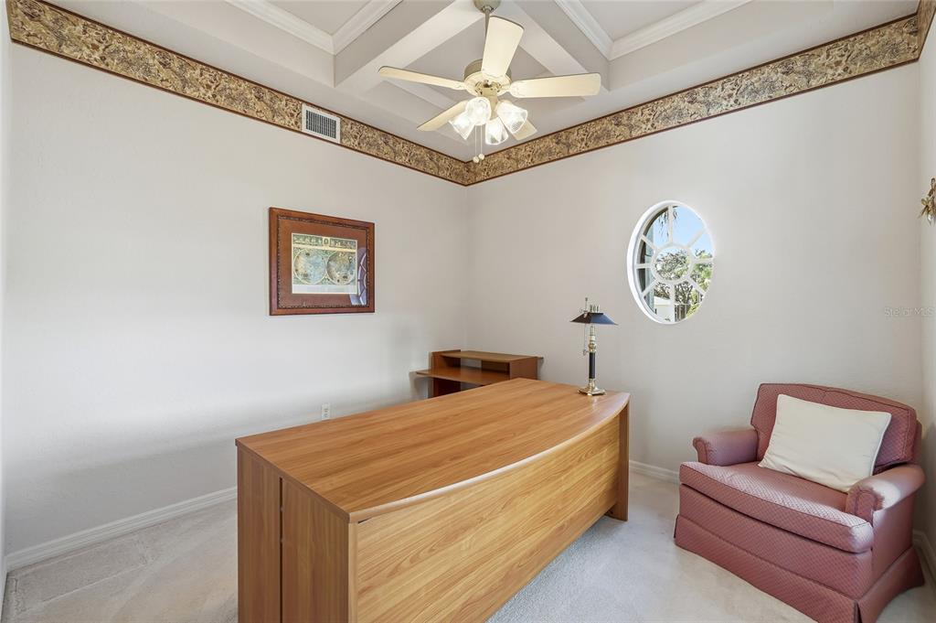 3521 Conifer Loop Spring Hill, FL 34609 - Photo 40 of 71 a bedroom with a bed and a chandelier
