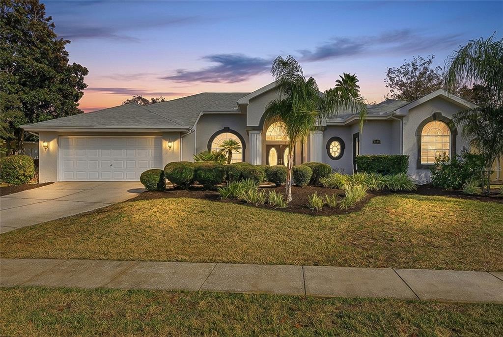 3521 Conifer Loop Spring Hill, FL 34609 - Photo 4 of 71 a front view of a house with garden