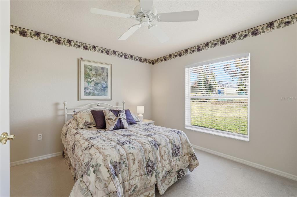 3521 Conifer Loop Spring Hill, FL 34609 - Photo 44 of 71 a bed sitting in a bedroom next to a window