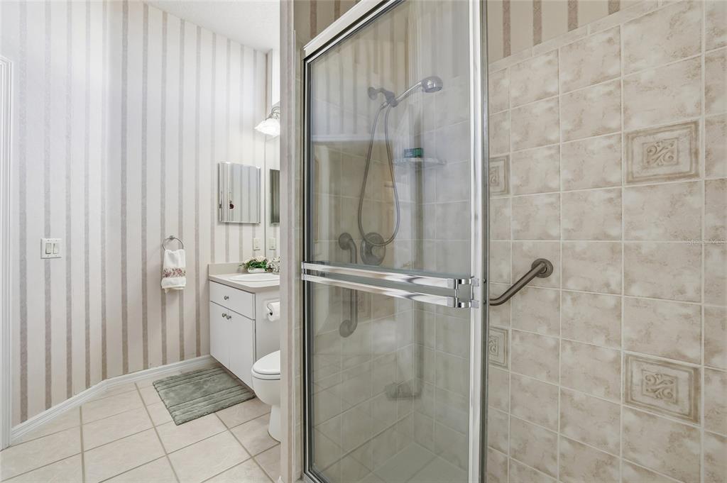 3521 Conifer Loop Spring Hill, FL 34609 - Photo 48 of 71 a bathroom with a glass shower door