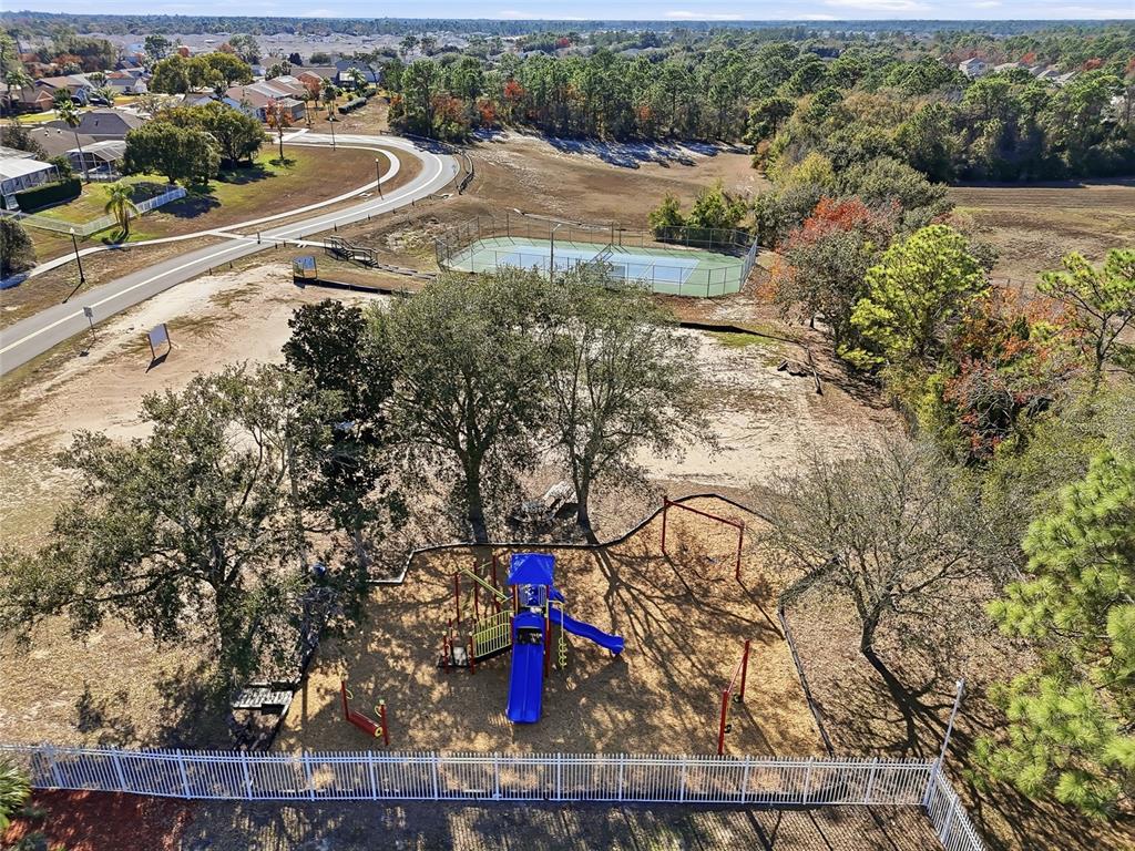 3521 Conifer Loop Spring Hill, FL 34609 - Photo 66 of 71 an aerial view of residential houses with outdoor space and trees