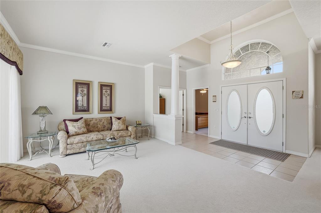 3521 Conifer Loop Spring Hill, FL 34609 - Photo 10 of 71 a living room with furniture a mirror and white walls