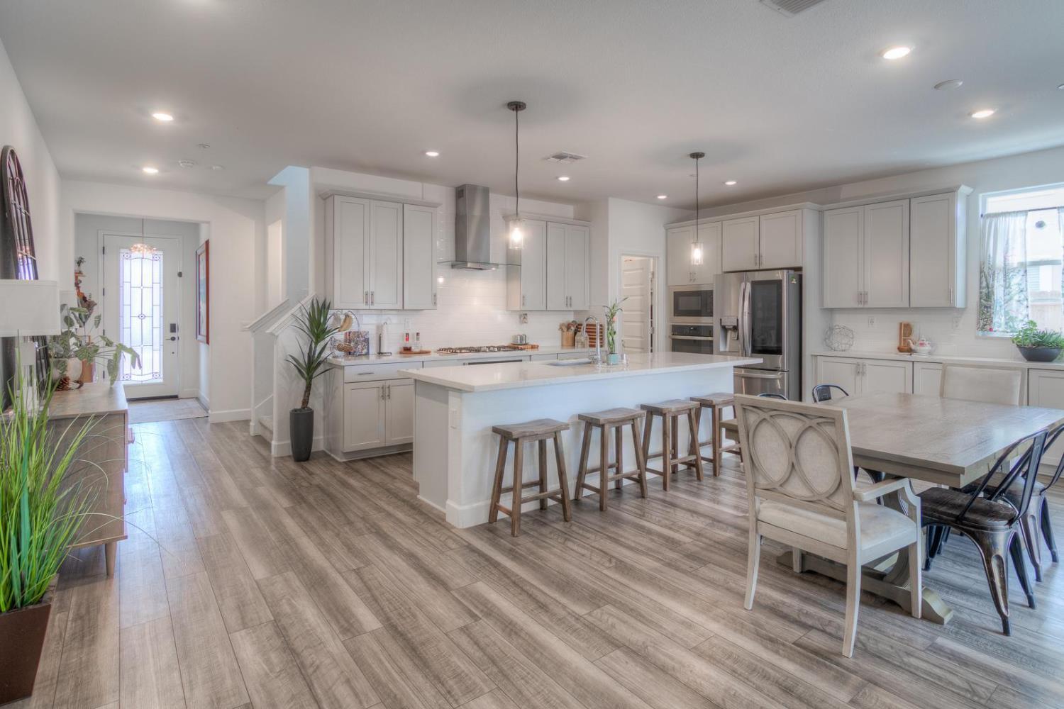 2116 Abbeyhill Road Lincoln, CA 95648 - Photo 9 of 46 an open kitchen with kitchen island wooden floor center island and stainless steel appliances