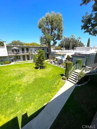 a view of a swimming pool with an outdoor seating and a yard