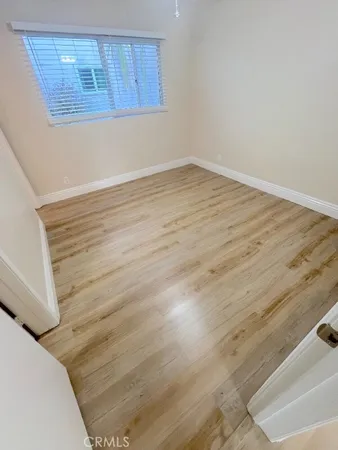 a view of a room with wooden floor and cabinet