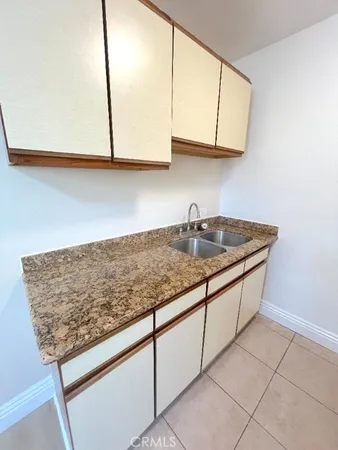 a kitchen with granite countertop cabinets and sink