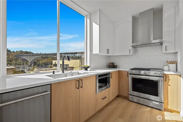 a kitchen with a sink stove top oven and cabinets